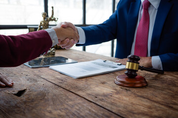 Lawyer and client shaking hands after legal agreement