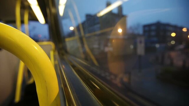 London Transport. A passengers point-of-view from the top of a London bus looking out with limited focus of the window of the top floor of a double decker bus.