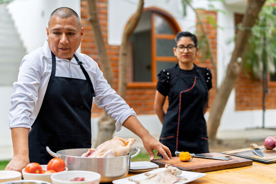 Chef preparing fresh ingredients for outdoor cooking