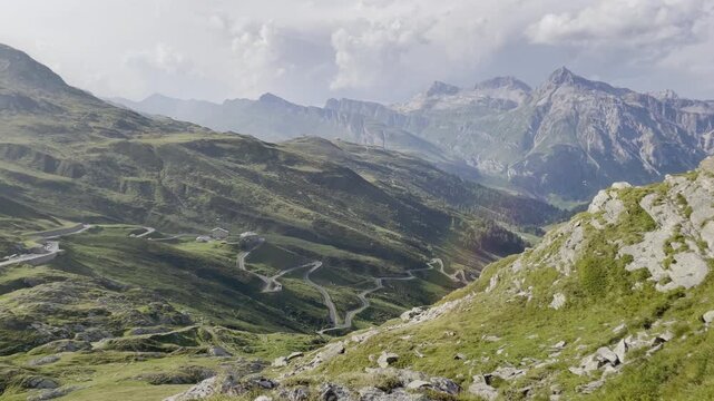 Pan of Splugen Pass hairpin turns with Teurihorn and lens flare - Italian Alps