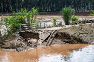 Pedestrian walkway collapsed after Kok river flooded and rising after heavy raining in Chiang Rai province, Thailand.