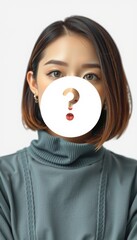 Asian woman with a question mark cutout obscuring her face against white.