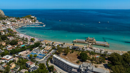 Fototapeta premium Aerial view of Mondello Beach, near Palermo, Sicily, Italy. It is a famous and beautiful tourist destination on the Mediterranean Sea. There are many houses and tourist accommodations.