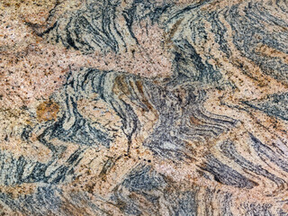Close up of random brown red marble with random black veins. Natural granite stone texture with black grains. Mineral natural stone. Seamless background texture.