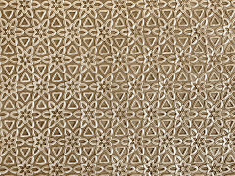 Close up of geometrical flower shape pattern cutouts in metallic gold paint finish. 3D cutout laser cut floral shapes suitable for screens or divider. Seamless background texture.