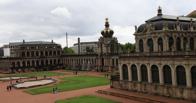 Dresden Germany historic Zwinger palace courtyard 4K. Industrial center of East Germany, now unified German, European Union (EU) and NATO. Total destruction in WW II. Palace rebuilt historically.
