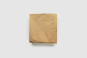 Brown Kraft Paper Wrapped Package on Grey Background