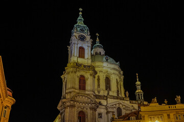 Beautiful aerial view St. Nicholas Church in the Lesser Town of Prague, Czech Republic — stunning baroque masterpiece surrounded by colorful old buildings and cobblestone streets