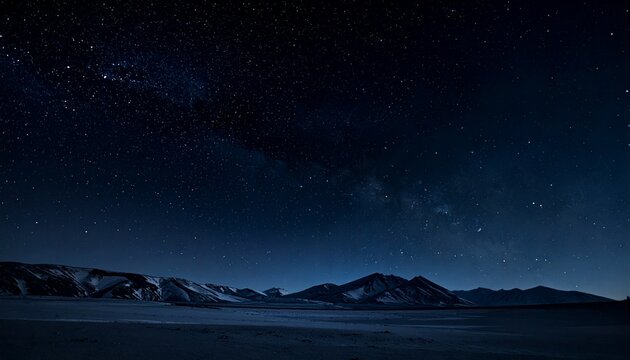 Night sky view with stars over a desert mountain range, natural landscape, celestial display, and astronomy