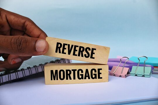 Reverse mortgage symbol. Concept words Reverse mortgage on wooden blocks. Beautiful background. 