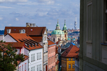 Beautiful aerial view St. Nicholas Church in the Lesser Town of Prague, Czech Republic — stunning baroque masterpiece surrounded by colorful old buildings and cobblestone streets