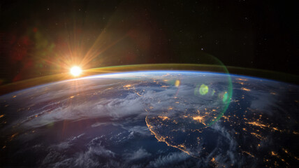 Fototapeta premium Sunrise over planet earth viewed from space satellite