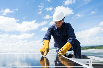 Engineer checking inspection solar cells on the roof.Technician maintaining solar panels on blue sky and white clouds background.Solar photovoltaic panel system and saving energy with clean power.