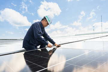 Engineer checking inspection solar cells on the roof.Technician maintaining solar panels on blue sky and white clouds background.Solar photovoltaic panel system and saving energy with clean power.