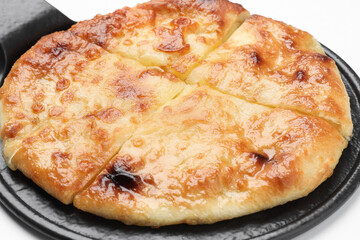 Cut delicious Megrelian khachapuri on white background, closeup