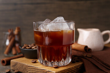 Tasty iced coffee and beans on wooden table, closeup