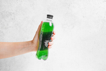 Bottle of Green Chrorophyll Water in hand