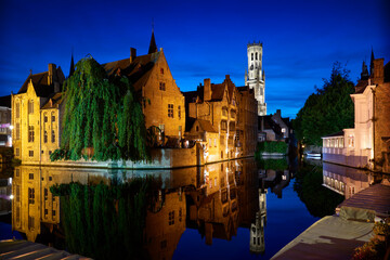 Fototapeta premium Historic Bruges Rozenhoedkaai Night Reflection. Dusk on the historic Rozenhoedkaai of Bruges, Belgium, with medieval buildings, canal and belfry.