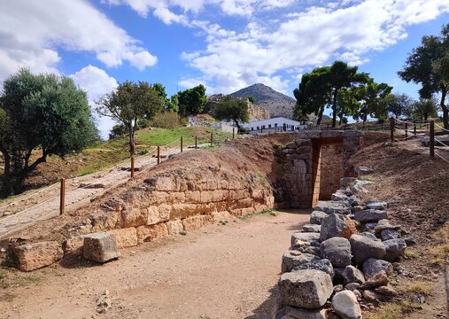 Photo of the entrance to the Lion Tholos Tomb, located northwest of the Mycenae citadel in Peloponnese, Greece. Dating to around 1350 BC, this smaller tomb features a circular chamber and burial pits.