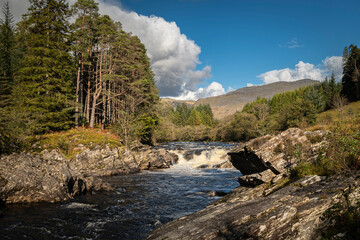 A bright autumnal HDR image of Easan Dubha waterfall cascading through Glen Orchy on its way to Loch Awe, Argyle and Bute, Scotland. 