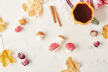 Autumnal cozy marshmallow mushrooms with tea cup, essence of fall decorations, treats top view.