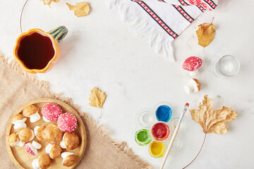 Autumn cozy tea party with creative marshmallow mushrooms for children the background of autumn decorations, handmade goodies.