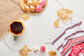 Autumn cozy tea party with marshmallow mushrooms for children, a cup of tea, the background of autumn decorations, handmade goodies.