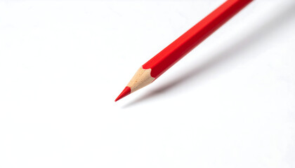 A single red pencil lying diagonally on a white background. Minimalist concept symbolizing creativity, focus, and individuality