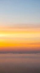 Obraz premium Vibrant Sunset Sky Over Calm Water Reflecting Colors.