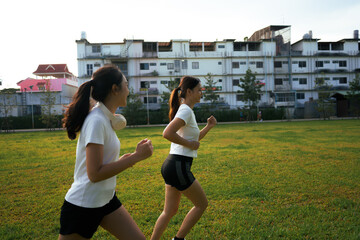 Young women jogging outdoors in green park