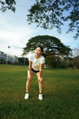 Young woman resting after exercise in park