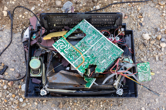 broken TV set in the trash, CRT, speaker, and controller electronics