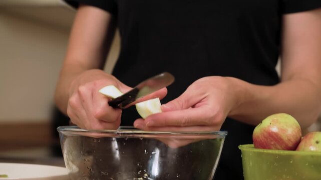 Removing apple core with knife preparing homemade compote. Cleaning fruit from seeds making ingredient for traditional drink. Cutting ripe apple refining base for sweet homemade beverage