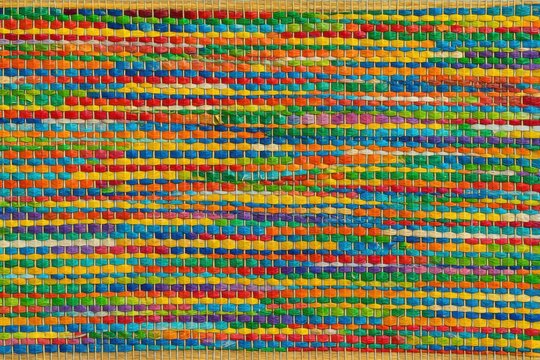 Vibrant texture mosaic of tightly woven colorful strands providing a mesmerizing design