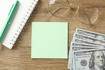 Alimony. Sticky note, money, stationery and glasses on wooden table, flat lay