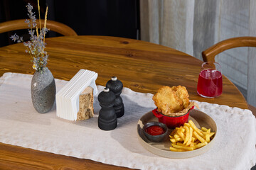 Indulge in Delicious Fried Chicken accompanied by Crispy French Fries and a Stylish Table Setting