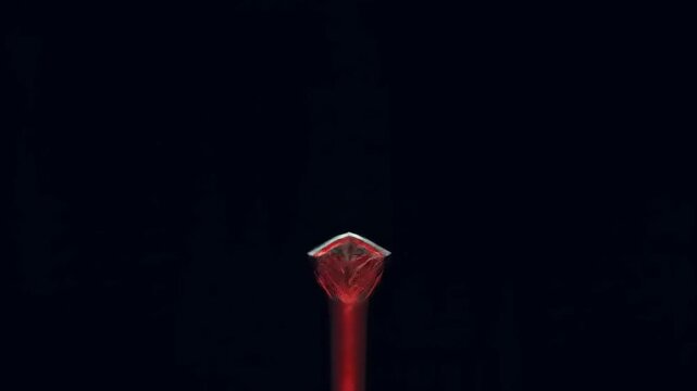 Futuristic red sword against black background digital illustration