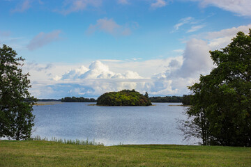 Picturesque water surface, island visible and beautiful clouds