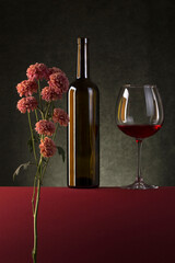 Still life with flowers, a bottle and a glass of wine