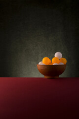 Still life with balls in a brown plate
