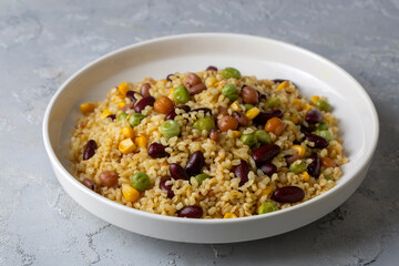 Bulgur pilaf with legumes; with peas, beans and corn kernels.