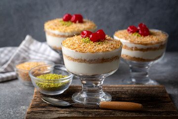 Traditional milky crispy Ramadan dessert custard pudding with roasted kadayif and diced pistachio . Kadayifi Muhallebi