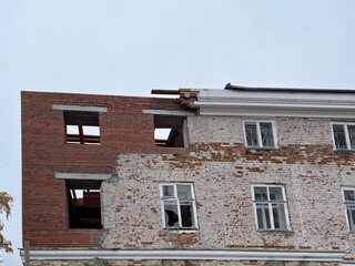 Restoration of a historically valuable old building by adding a red brick wall. Restoration of architectural historical heritage