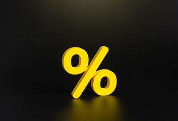 Yellow percentage symbol on a dark background. Financial services, loans, and deposits. Symbol of interest rates, sales, and discounts. Finance, banking, and retail promotions.
