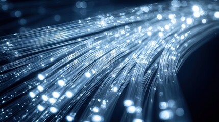 Macro cable detail fiber optic cable bundle with glowing light trails streaming through glass cores curved composition dynamic flow