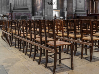 Simple rustic chairs in a church in France