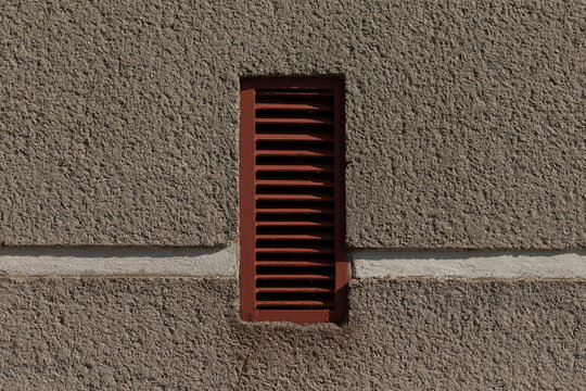 rusty vent secured, weathered louver with padlock on textured surface, rusty vent firmly secured with padlock against textured surface, corroded vent securely fastened with padlock on textured wall