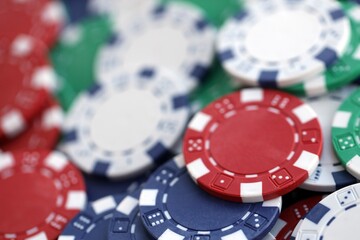 Close up of a group of casino chips on a green mat for poker or dice games indoors