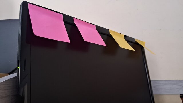 Colorful Post-its sticking to a computer screen