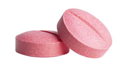 Two pink pills on a white background